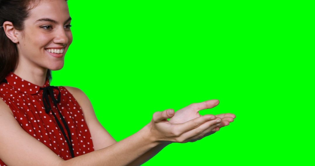 Smiling Woman Holding Out Hands on Green Screen Background - Free Images, Stock Photos and Pictures on Pikwizard.com