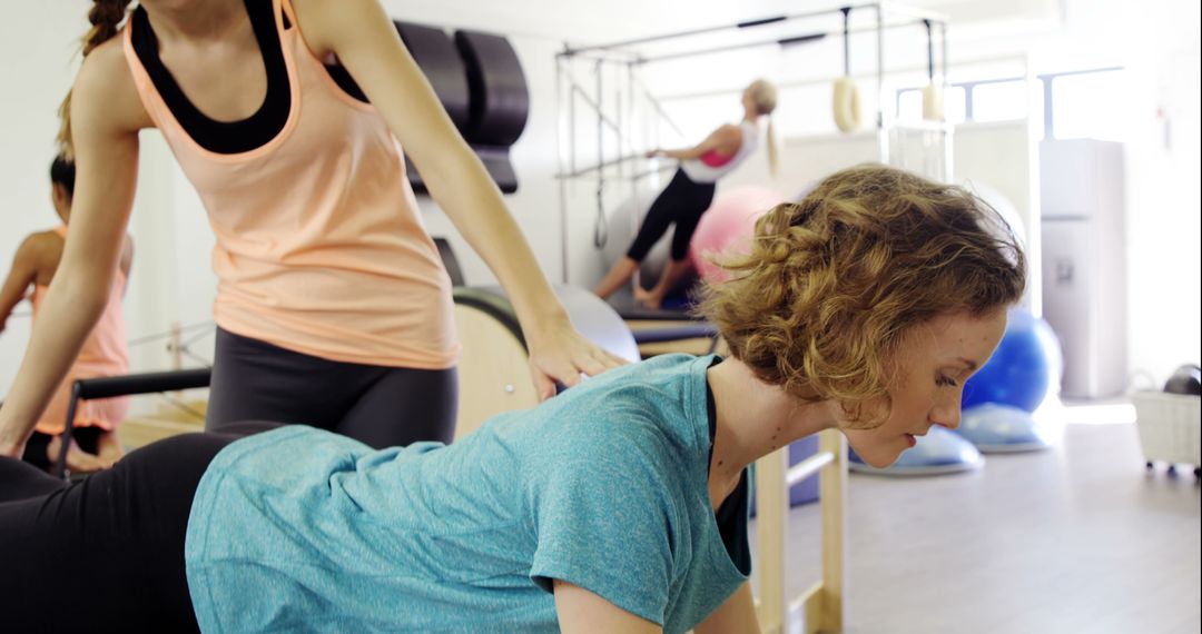 Women Engaging in Pilates Workout with Instructor Guidance - Free Images, Stock Photos and Pictures on Pikwizard.com