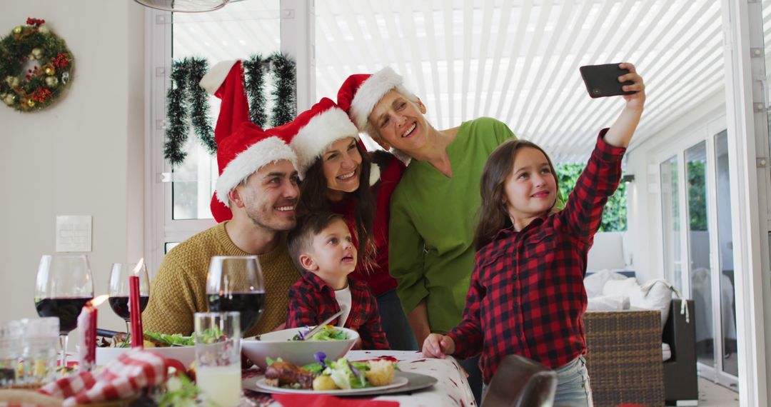 Family Celebrating Christmas with Selfie at Festive Dinner - Free Images, Stock Photos and Pictures on Pikwizard.com