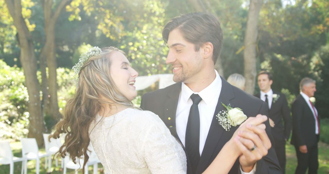 A young Caucasian bride and groom share a joyful dance outdoors, with copy space - Free Images, Stock Photos and Pictures on Pikwizard.com