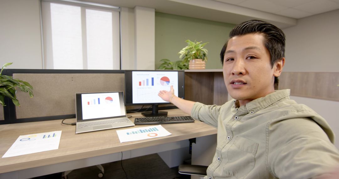 Business Presentation with Laptop and Graphs in Office Setting