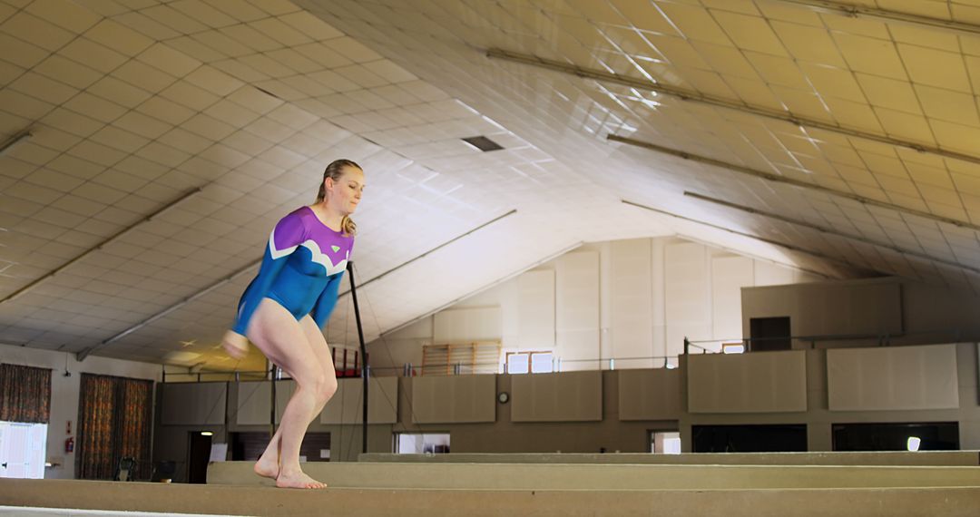 Young Gymnast Practicing Beam Routine in Training Facility - Free Images, Stock Photos and Pictures on Pikwizard.com