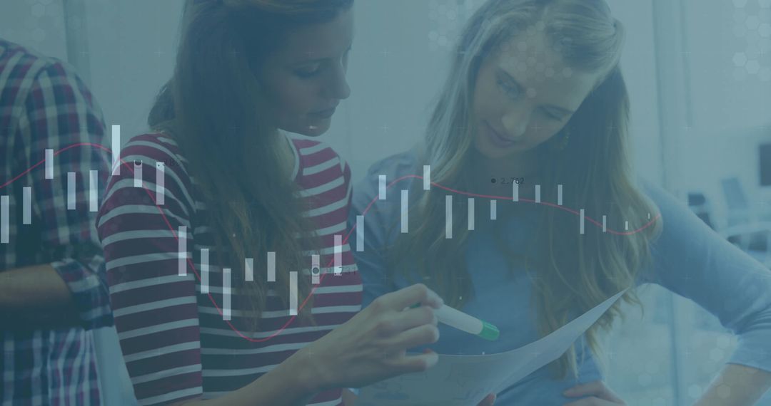 Two Women Analyzing Business Statistics at Work