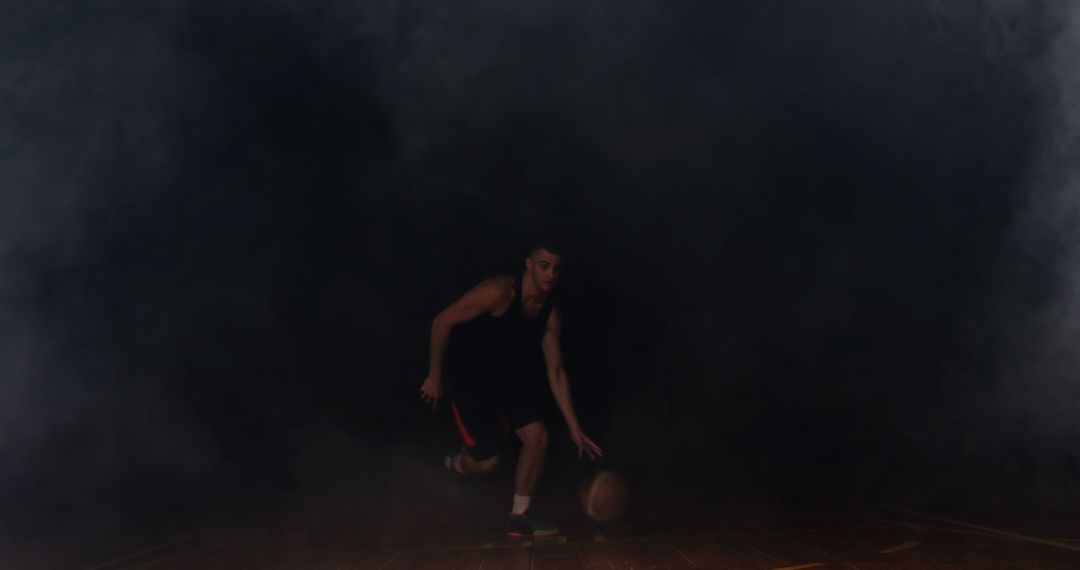 Basketball Player Dribbling in Dimly Lit Court with Smoke - Free Images, Stock Photos and Pictures on Pikwizard.com