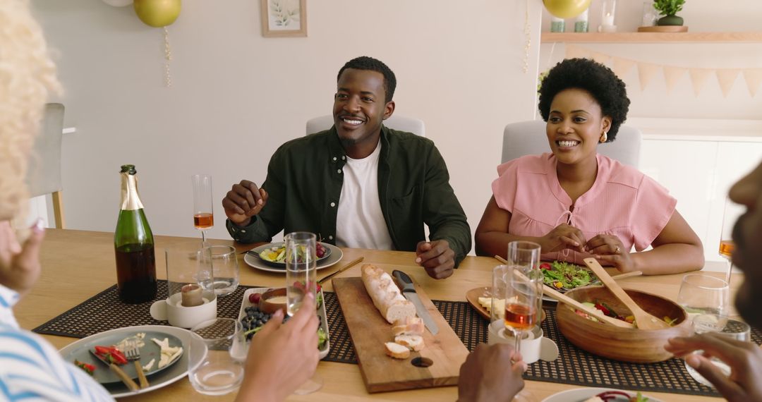 Friends Gathering at Dinner Table Enjoying Lively Meal