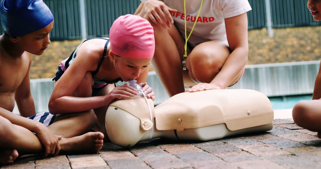 Young Swimmers Learning CPR From Lifeguard at Poolside - Free Images, Stock Photos and Pictures on Pikwizard.com