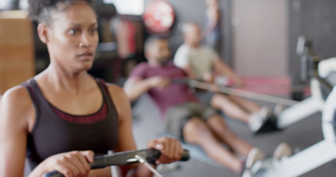 Focused Woman Doing Cardio Rowing Exercise in Gym - Free Images, Stock Photos and Pictures on Pikwizard.com