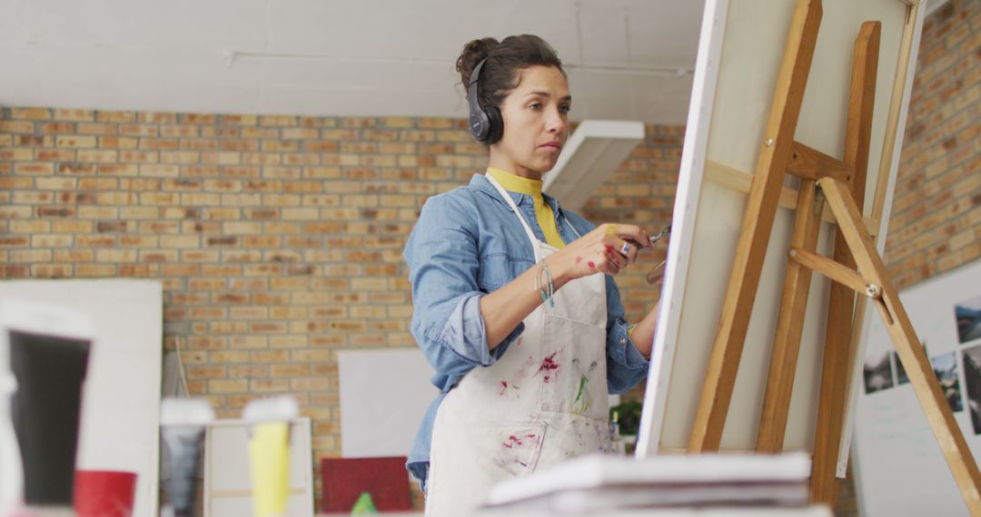 Female Artist Painting on Canvas While Listening to Music - Free Images, Stock Photos and Pictures on Pikwizard.com