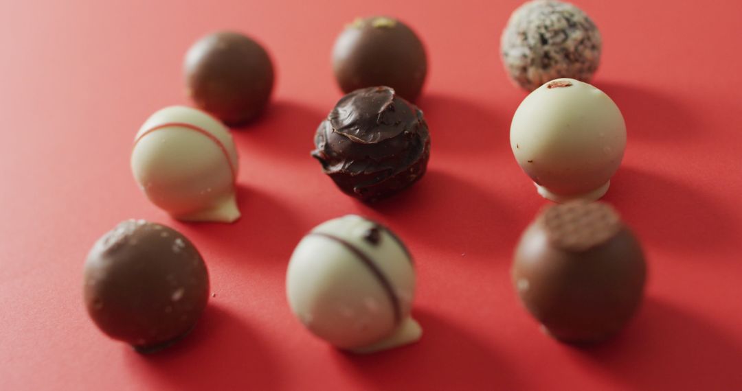Assorted Chocolates on Vibrant Pink Background for Valentine's Day