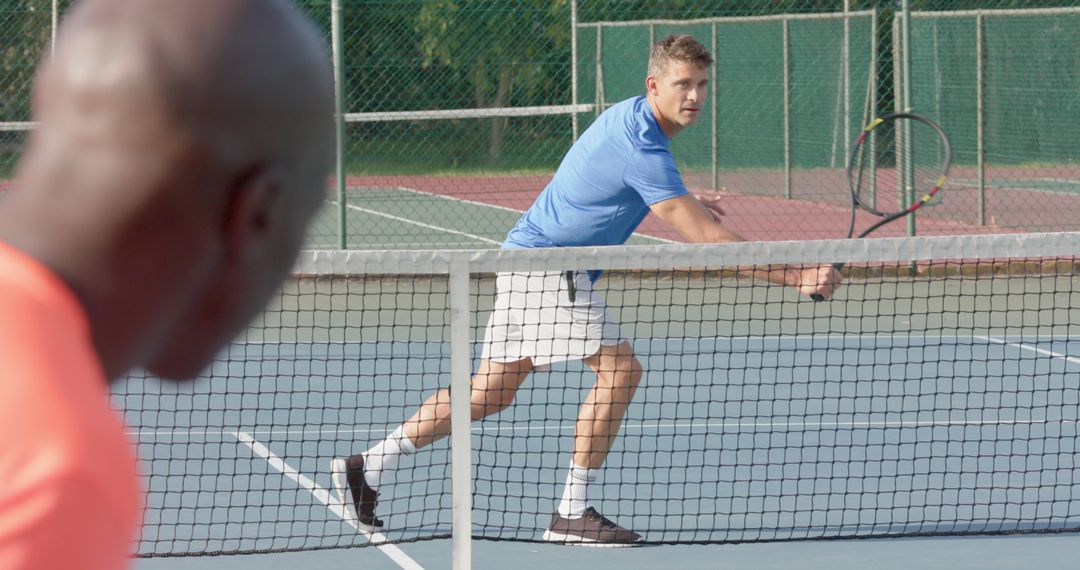 Men playing competitive tennis match on outdoor court - Free Images, Stock Photos and Pictures on Pikwizard.com