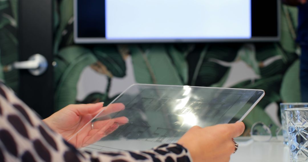 Person using transparent tablet during business meeting with presentation screen - Free Images, Stock Photos and Pictures on Pikwizard.com