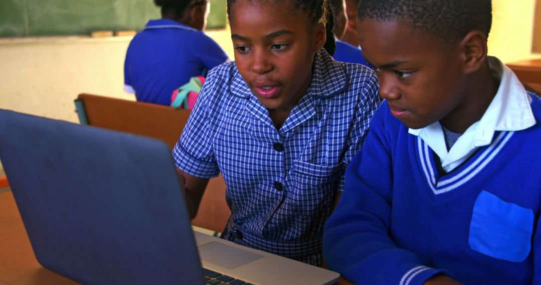 African Schoolchildren Collaborating on Laptop in Classroom - Free Images, Stock Photos and Pictures on Pikwizard.com