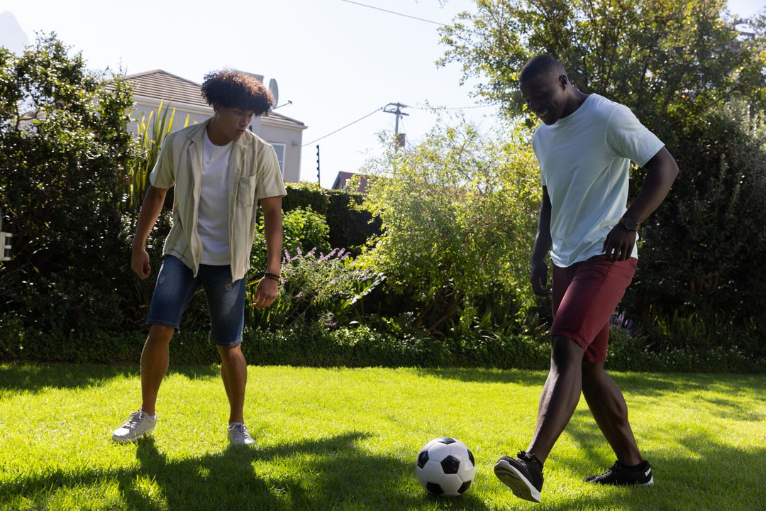 Two Friends Engaging in a Friendly Soccer Match on Sunny Day