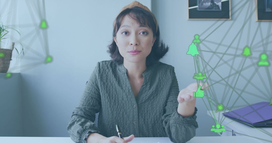 Businesswoman Analyzing Digital Networking Icons At Office Desk - Free Images, Stock Photos and Pictures on Pikwizard.com