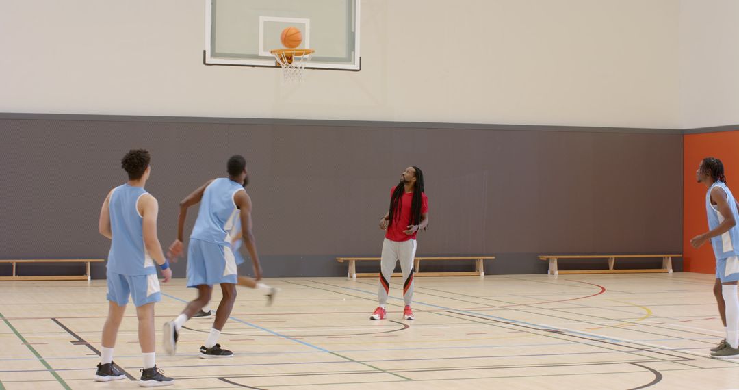 Basketball Team Practicing Driven Shooting in Indoor Court