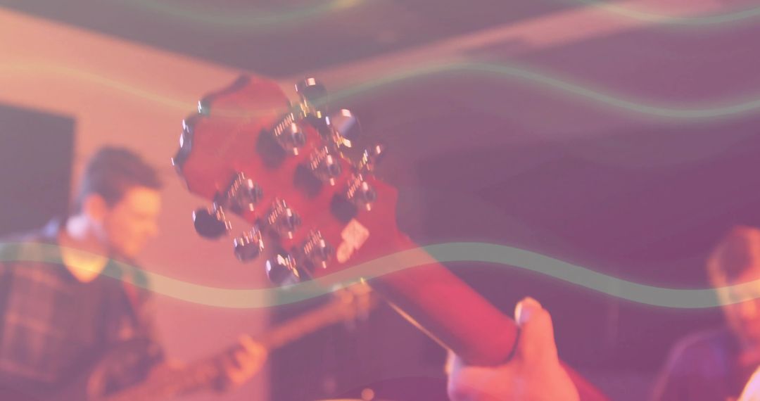 Musicians Practicing in Hazy Studio with Guitar Focus