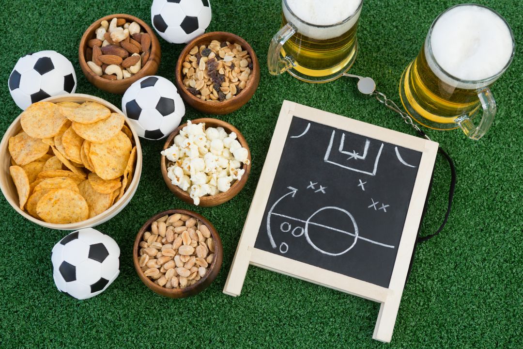 Football Strategy Board with Snacks and Beers on Artificial Grass - Free Images, Stock Photos and Pictures on Pikwizard.com