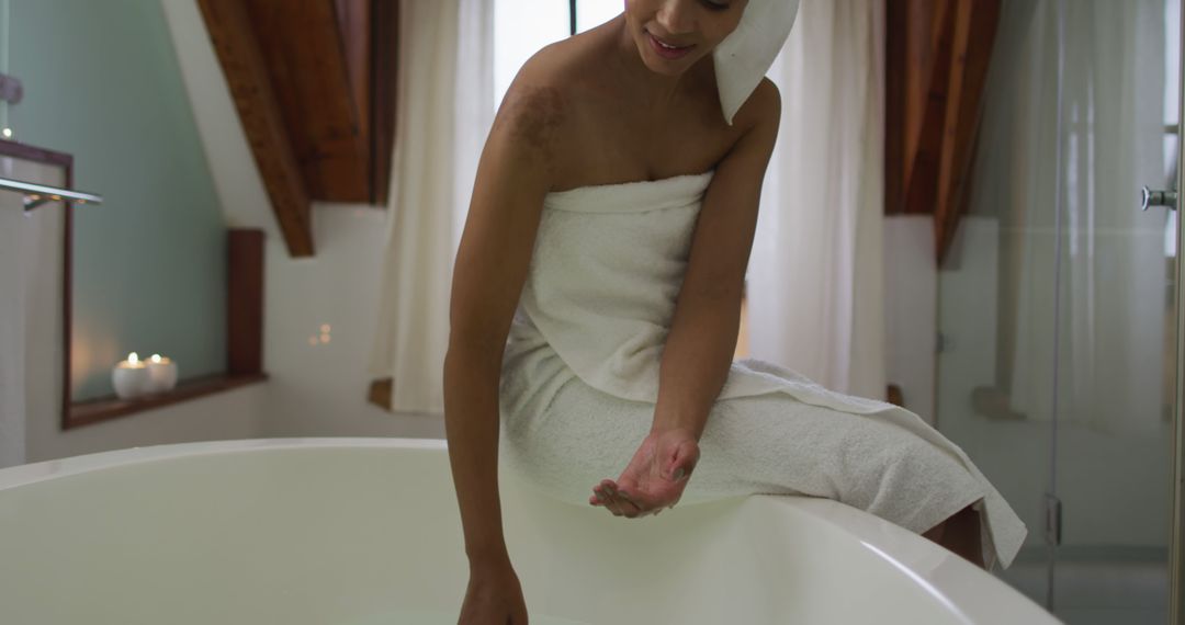 Biracial woman running a bath - Free Images, Stock Photos and Pictures on Pikwizard.com