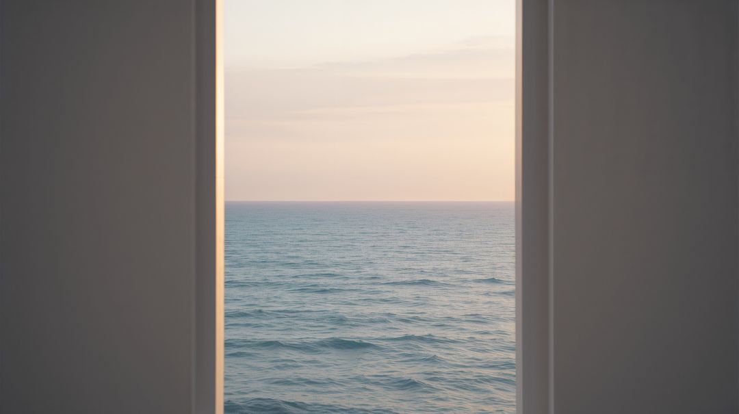 Minimalist framed view revealing rippling sea at dawn with pastel sky and warm light