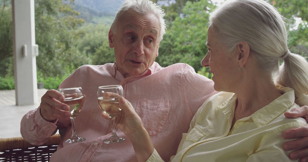 Senior Couple Relaxing with Wine in Outdoor Balcony - Free Images, Stock Photos and Pictures on Pikwizard.com