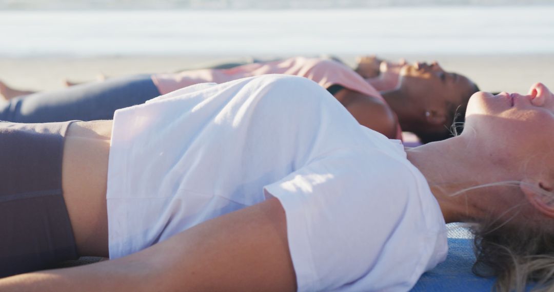 People Relaxing While Doing Yoga on Beach During Sunset - Free Images, Stock Photos and Pictures on Pikwizard.com