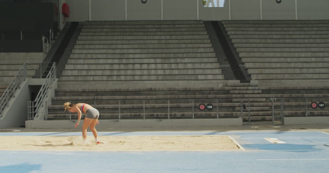 Female Athlete Practicing Long Jump in Indoor Stadium - Free Images, Stock Photos and Pictures on Pikwizard.com