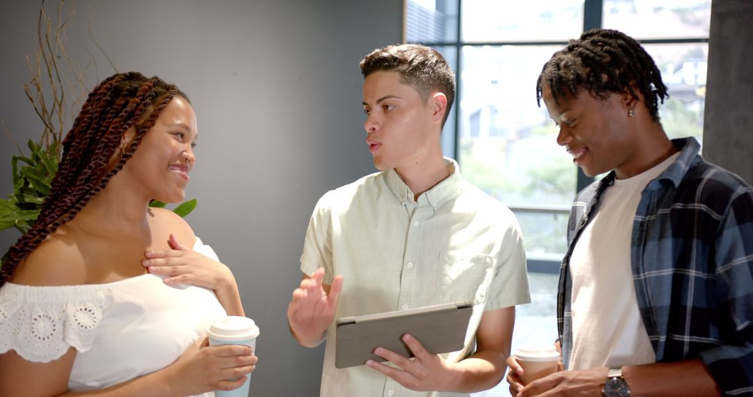 Diverse Colleagues Discussing Project with Tablet in Office