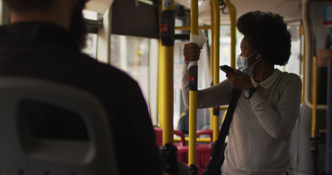 Woman with Face Mask Using Smartphone in Public Transport