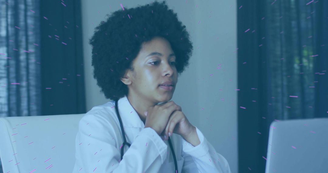 Focused Female Doctor Analyzing Data on Laptop in Medical Office