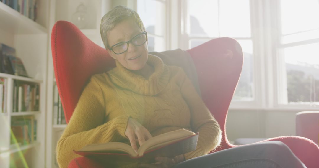 Senior Woman Reading Book in Bright Cozy Living Room - Free Images, Stock Photos and Pictures on Pikwizard.com