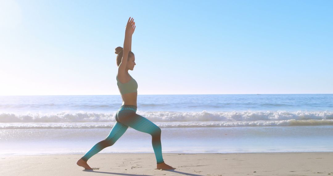 Woman Practicing Yoga Warrior Pose on Beach During Sunrise - Free Images, Stock Photos and Pictures on Pikwizard.com