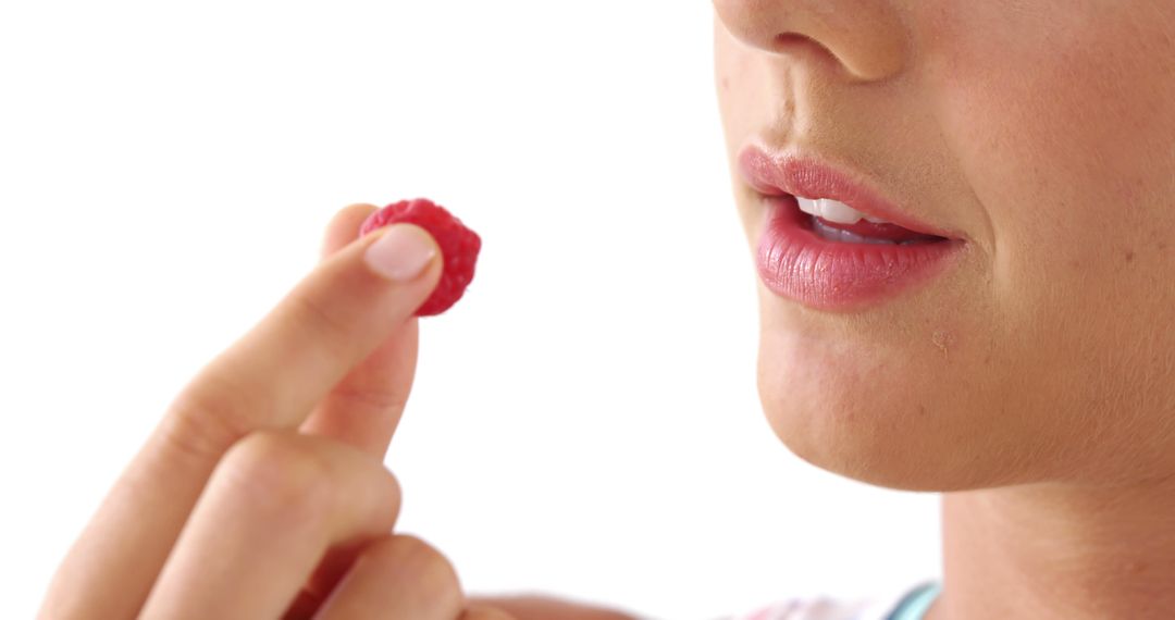 Close-Up of Person Holding Fresh Raspberry Near Mouth - Free Images, Stock Photos and Pictures on Pikwizard.com