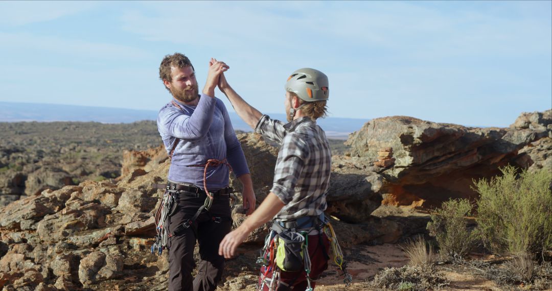 Two Rock Climbers Celebrating Success with High Five