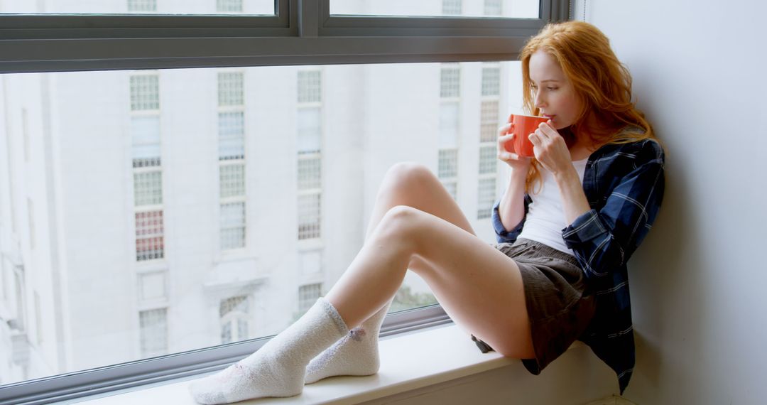 Young Woman Enjoying Coffee by Window Seat in Cozy Apartment - Free Images, Stock Photos and Pictures on Pikwizard.com