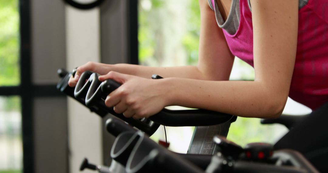 Close-Up of Person Using Exercise Bike in Gym - Free Images, Stock Photos and Pictures on Pikwizard.com