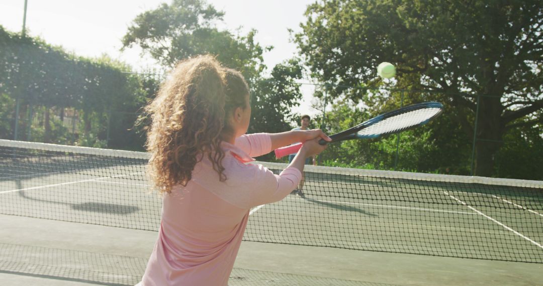 Woman Playing Tennis on Sunny Outdoor Court - Free Images, Stock Photos and Pictures on Pikwizard.com