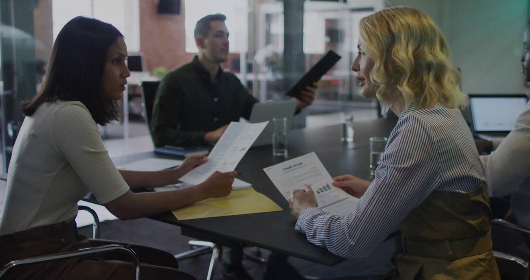 Team Collaboration with Printed Reports in Modern Office Meeting