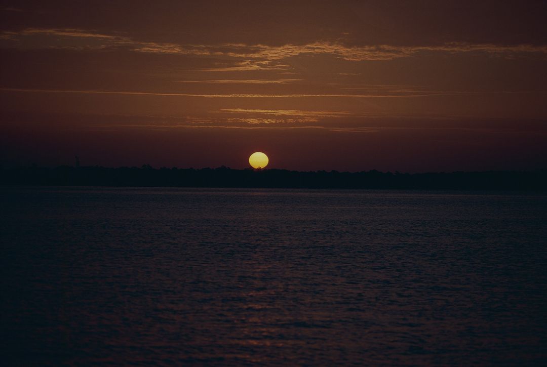 Golden Sunset Over Calm Ocean Waters - Free Images, Stock Photos and Pictures on Pikwizard.com