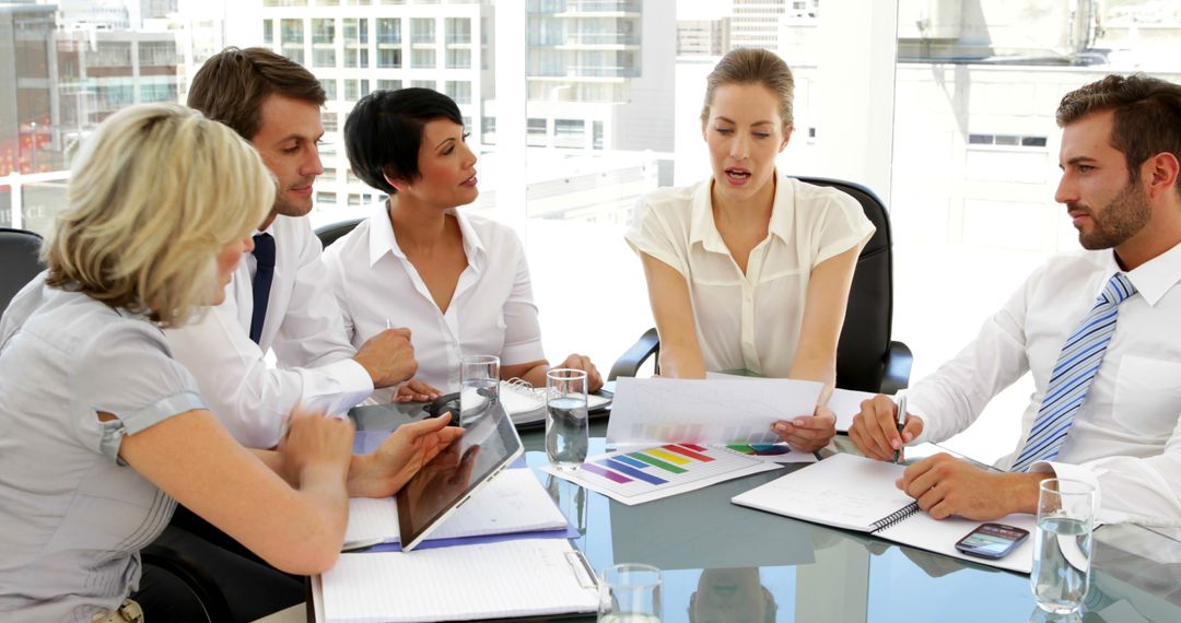 Happy Business Team Reviewing Financial Reports in Office Meeting - Free Images, Stock Photos and Pictures on Pikwizard.com