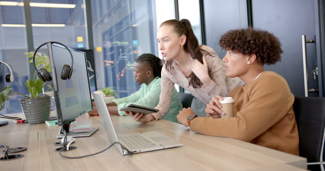 Diverse Team Collaborating in Office with Modern Technology