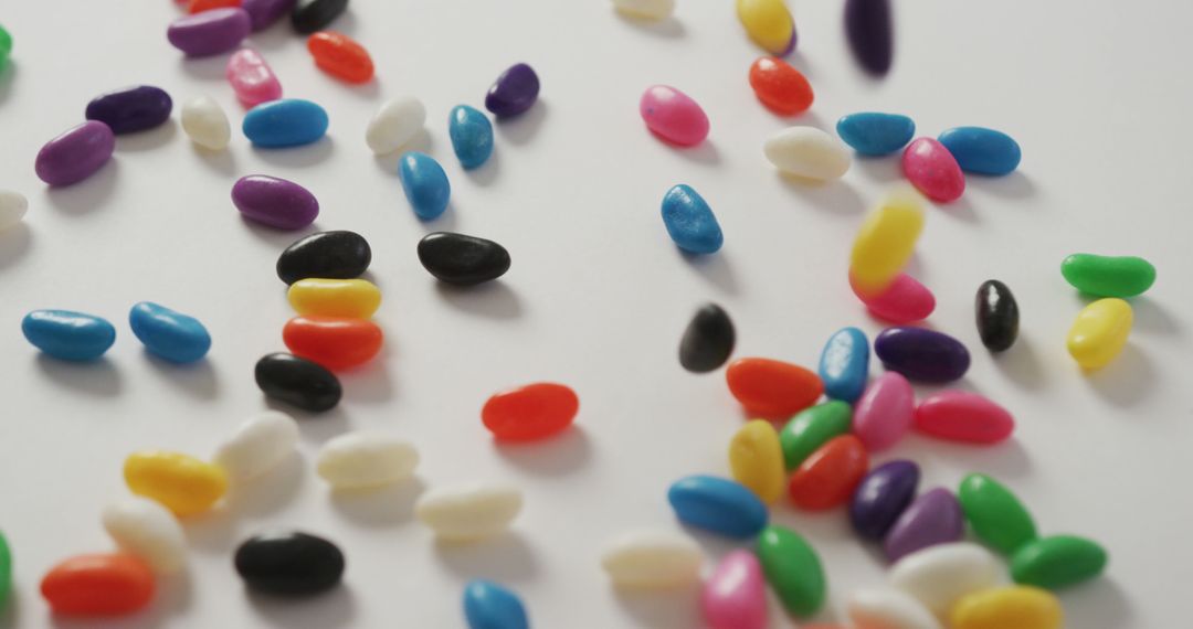 Colorful Jelly Beans Spilled on White Background - Free Images, Stock Photos and Pictures on Pikwizard.com