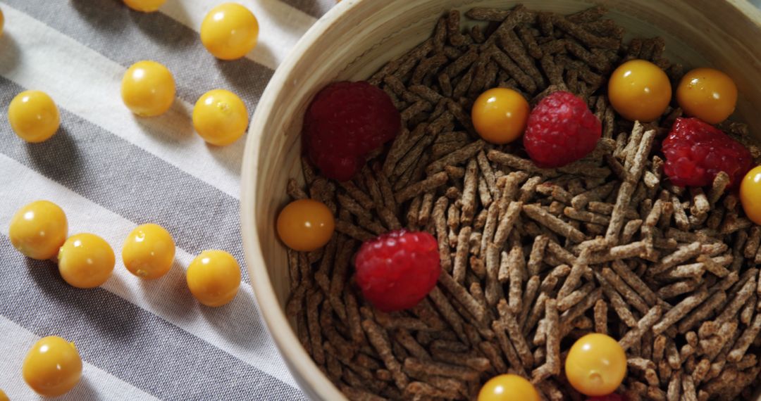 Healthy Breakfast Bowl with Raspberries and Golden Berries - Free Images, Stock Photos and Pictures on Pikwizard.com