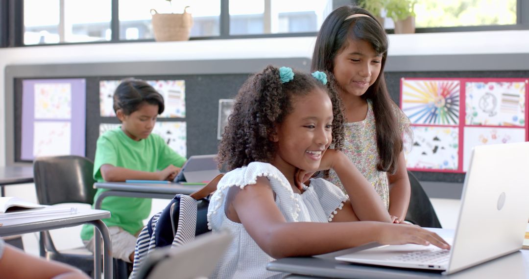 Students Collaborating on School Project with Laptop in Classroom