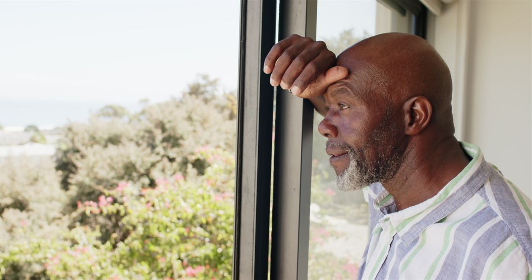 Mature Man Contemplating Peacefully by Window