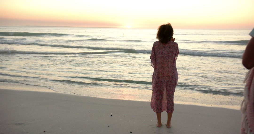 Serene Sunset on Sandy Beach with Gently Lapping Waves
