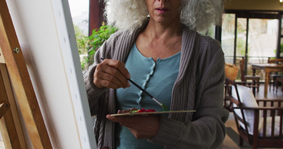 Senior biracial woman painting on balcony - Free Images, Stock Photos and Pictures on Pikwizard.com