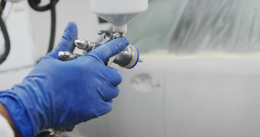 Close-Up of Worker Painting Car with Spray Gun in Auto Body Shop - Free Images, Stock Photos and Pictures on Pikwizard.com