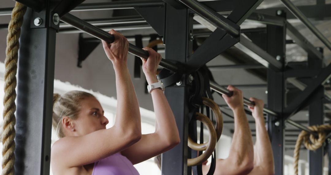 Woman Exercising with Pull-ups on Metal Bar in Gym - Free Images, Stock Photos and Pictures on Pikwizard.com