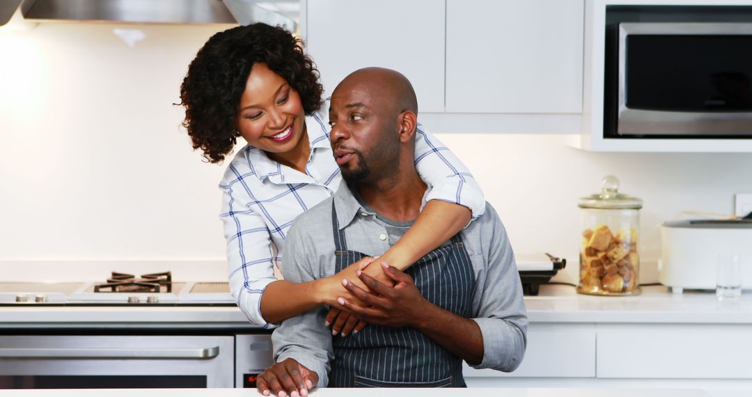 Affectionate Couple Embracing in Modern Kitchen Setting
