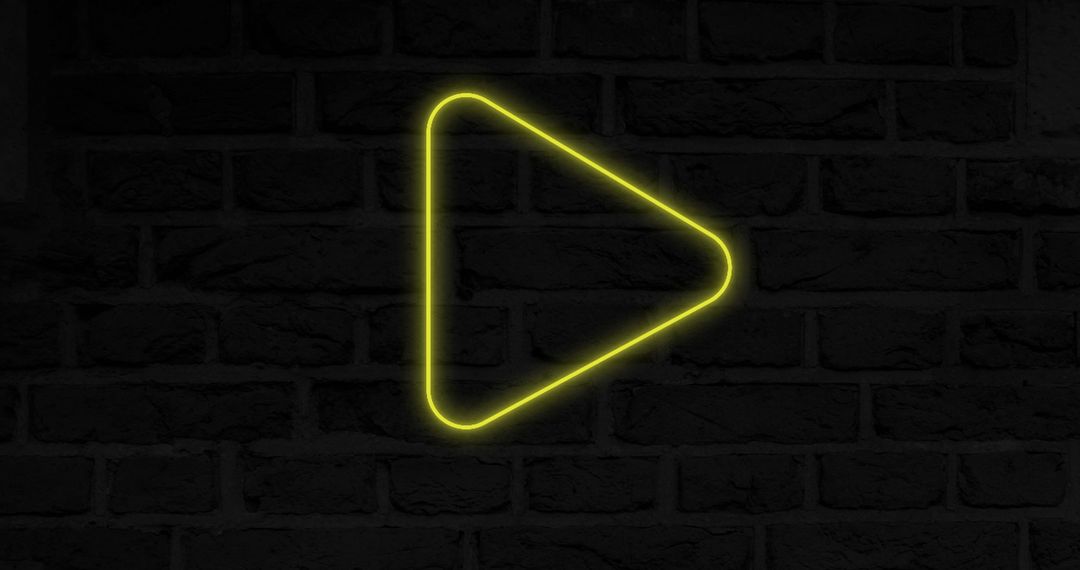 Neon Play Icon Glowing Over Brick Wall Background - Free Images, Stock Photos and Pictures on Pikwizard.com